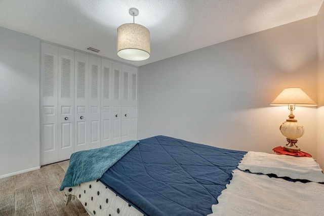 bedroom featuring wood finished floors and baseboards