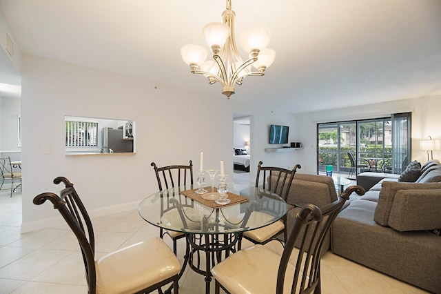dining room with light tile patterned floors, a chandelier, and baseboards