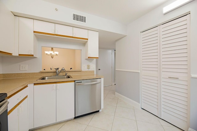 kitchen with stainless steel dishwasher, a sink, a chandelier, light countertops, and white cabinetry