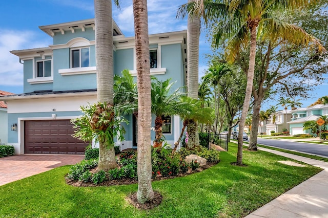 40 Country Lake Cir, Boynton Beach, FL 33436 - view of front of house with stucco siding, a garage, and a front yard