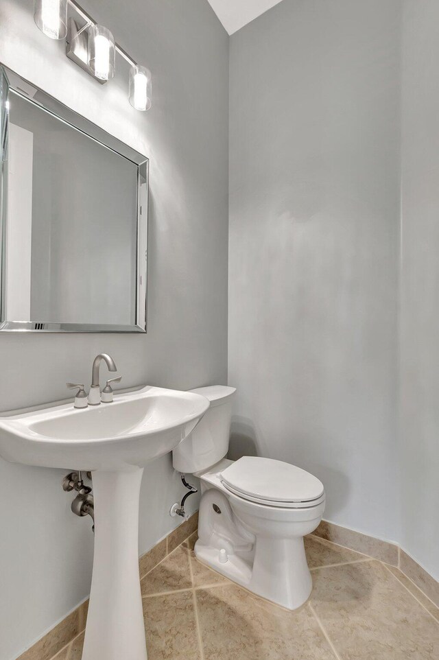 40 Country Lake Cir, Boynton Beach, FL 33436 - half bath with toilet, baseboards, and tile patterned floors
