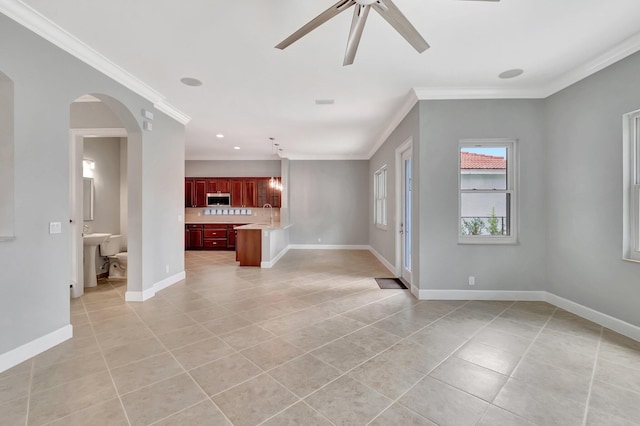 40 Country Lake Cir, Boynton Beach, FL 33436 - unfurnished living room featuring crown molding, light tile patterned flooring, arched walkways, ceiling fan, and baseboards