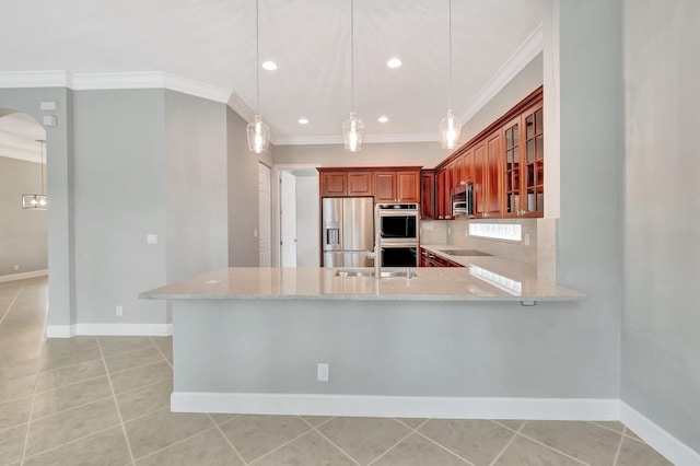40 Country Lake Cir, Boynton Beach, FL 33436 - kitchen featuring stainless steel appliances, crown molding, a sink, baseboards, and light stone countertops