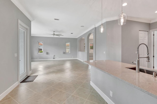 40 Country Lake Cir, Boynton Beach, FL 33436 - kitchen with ornamental molding, light tile patterned floors, ceiling fan, light stone counters, and baseboards