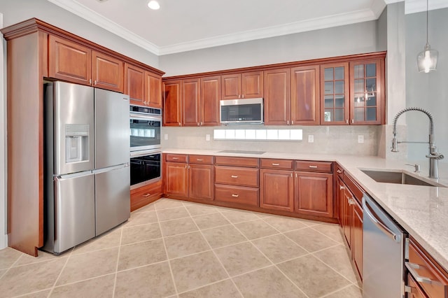 40 Country Lake Cir, Boynton Beach, FL 33436 - kitchen featuring stainless steel appliances, a sink, ornamental molding, brown cabinets, and recessed lighting