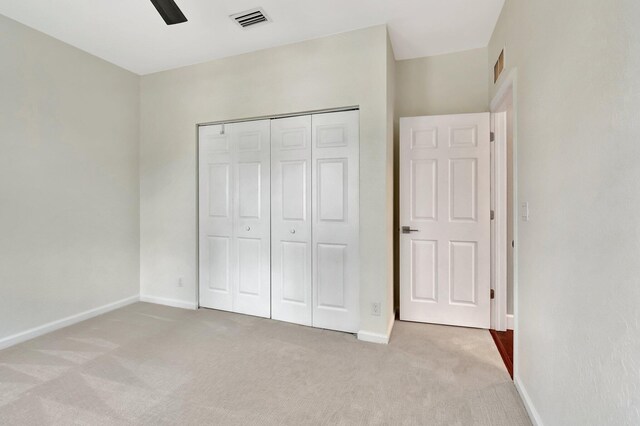 40 Country Lake Cir, Boynton Beach, FL 33436 - unfurnished bedroom with light colored carpet, baseboards, a closet, and ceiling fan
