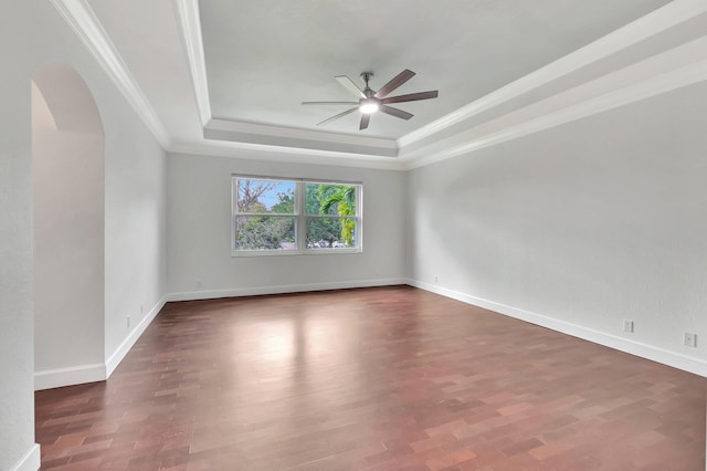 40 Country Lake Cir, Boynton Beach, FL 33436 - spare room featuring ceiling fan, a raised ceiling, arched walkways, crown molding, and wood finished floors