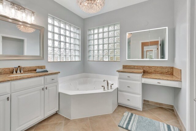 40 Country Lake Cir, Boynton Beach, FL 33436 - bathroom featuring plenty of natural light, tile patterned flooring, a whirlpool tub, and vanity