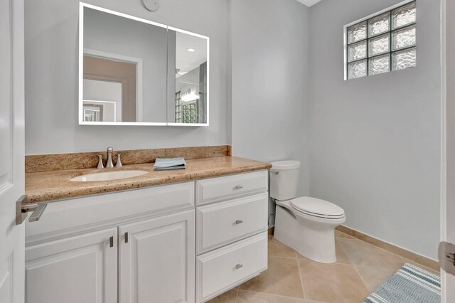 40 Country Lake Cir, Boynton Beach, FL 33436 - bathroom with tile patterned floors, toilet, vanity, and baseboards