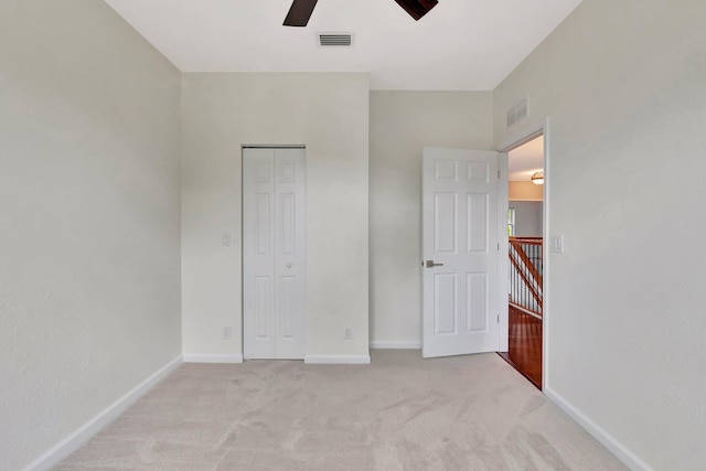 40 Country Lake Cir, Boynton Beach, FL 33436 - unfurnished bedroom with light colored carpet, a closet, baseboards, and ceiling fan