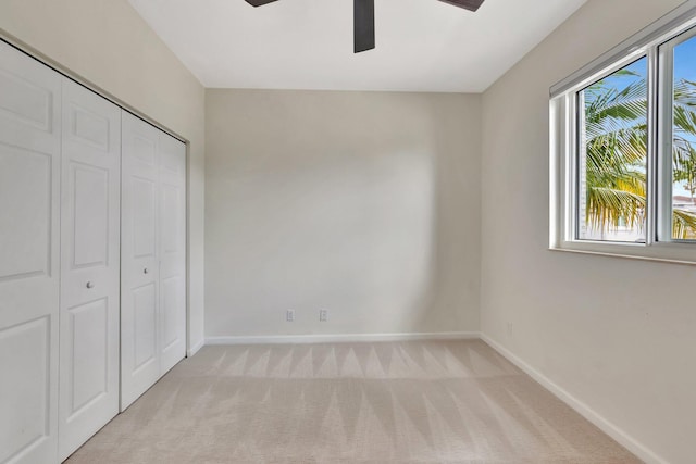40 Country Lake Cir, Boynton Beach, FL 33436 - unfurnished bedroom featuring light carpet, a closet, baseboards, and a ceiling fan