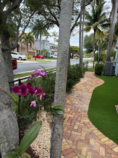 40 Country Lake Cir, Boynton Beach, FL 33436 - view of yard featuring central AC, fence, and a residential view