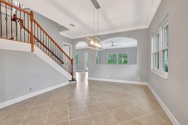 40 Country Lake Cir, Boynton Beach, FL 33436 - unfurnished dining area featuring arched walkways, a ceiling fan, crown molding, tile patterned flooring, and stairway