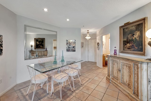 dining space with light tile patterned floors, recessed lighting, and a textured ceiling