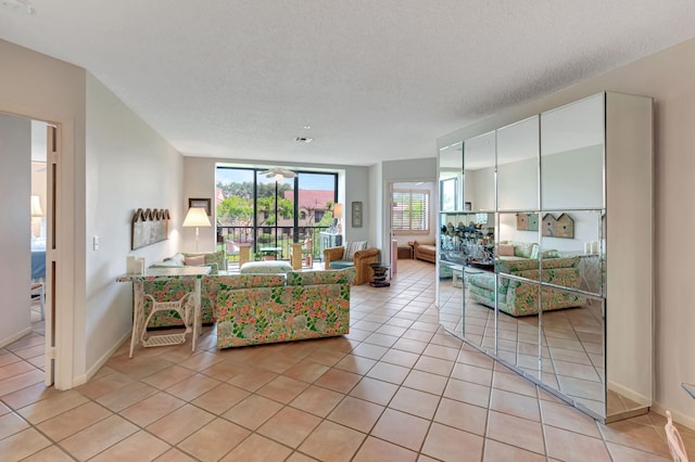 living area with light tile patterned floors and baseboards