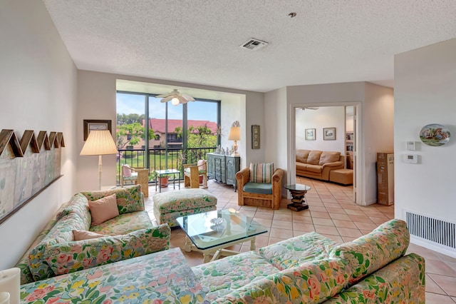 living area with light tile patterned flooring and a textured ceiling