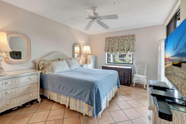 bedroom with light tile patterned floors, a textured ceiling, and ceiling fan