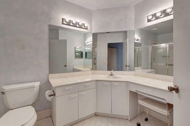 bathroom with toilet, a shower stall, vanity, and tile patterned flooring
