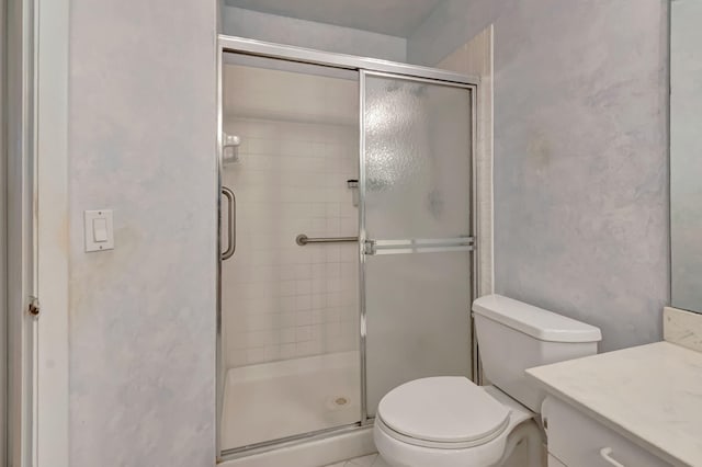 full bath featuring a shower stall, vanity, and toilet