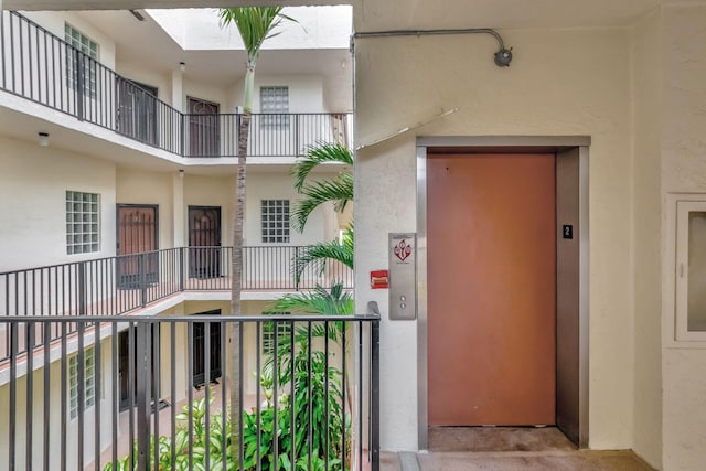 entrance to property with elevator and stucco siding