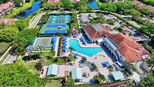 drone / aerial view of a large body of water and a pool area