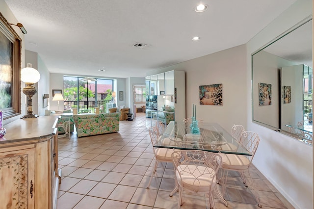 dining room featuring recessed lighting, light tile patterned flooring, and baseboards