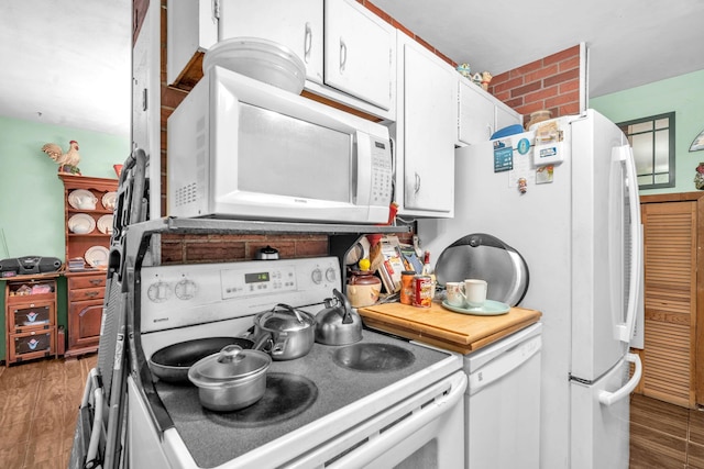 730 NE 23rd Pl, Pompano Beach, FL 33064 - kitchen featuring white appliances, white cabinetry, and light wood-type flooring