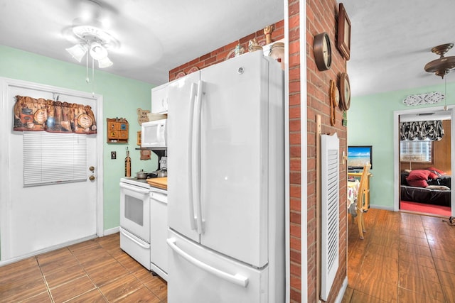 730 NE 23rd Pl, Pompano Beach, FL 33064 - kitchen with white appliances, ceiling fan, white cabinets, light wood finished floors, and light countertops