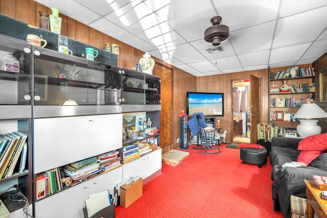 730 NE 23rd Pl, Pompano Beach, FL 33064 - living room with wooden walls, a drop ceiling, and carpet