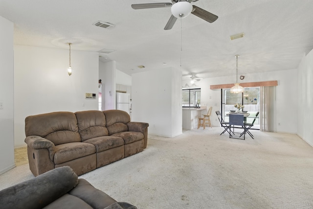 living room with ceiling fan, light colored carpet, and vaulted ceiling
