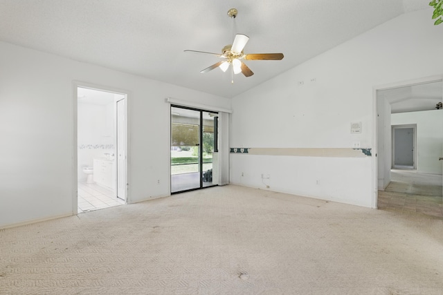carpeted spare room with lofted ceiling and ceiling fan