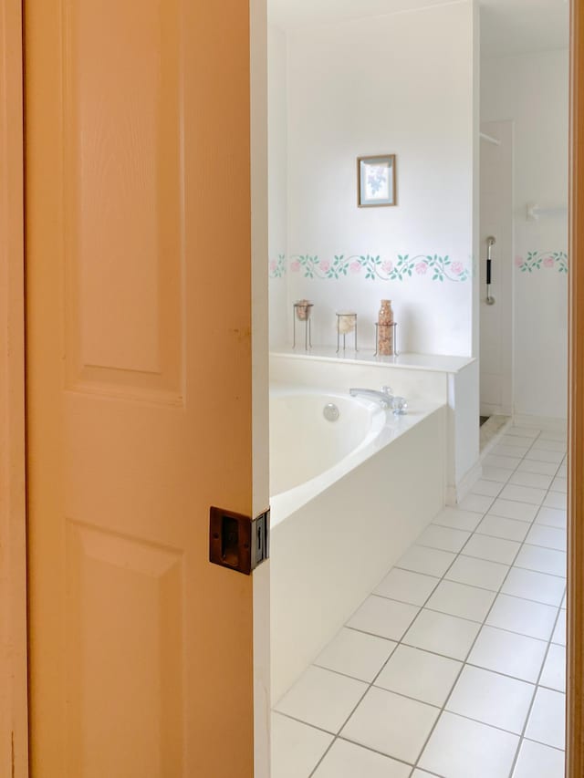 full bath featuring tile patterned floors and a bath