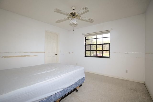 carpeted bedroom featuring a ceiling fan and baseboards