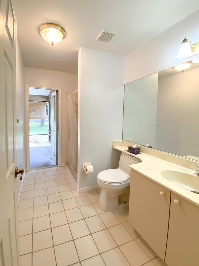 bathroom with tile patterned floors, toilet, curtained shower, and vanity