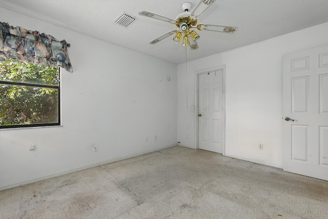 empty room with carpet flooring and ceiling fan