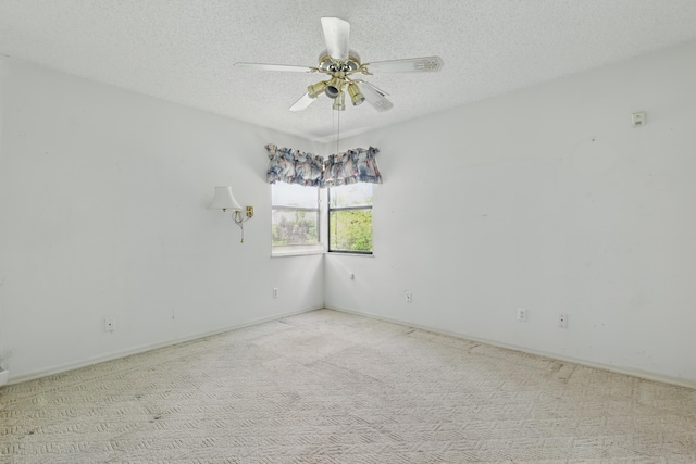unfurnished room with carpet, a textured ceiling, and ceiling fan