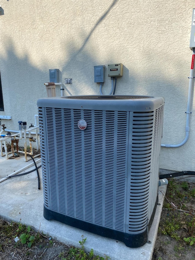 exterior view of cooling unit and stucco siding