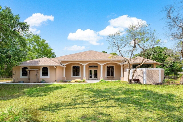 16737 Temple Blvd, Loxahatchee, FL 33470 - rear view of property featuring french doors, stucco siding, and a yard