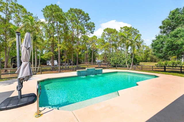 16737 Temple Blvd, Loxahatchee, FL 33470 - view of pool featuring a patio area, fence, and view of wooded area