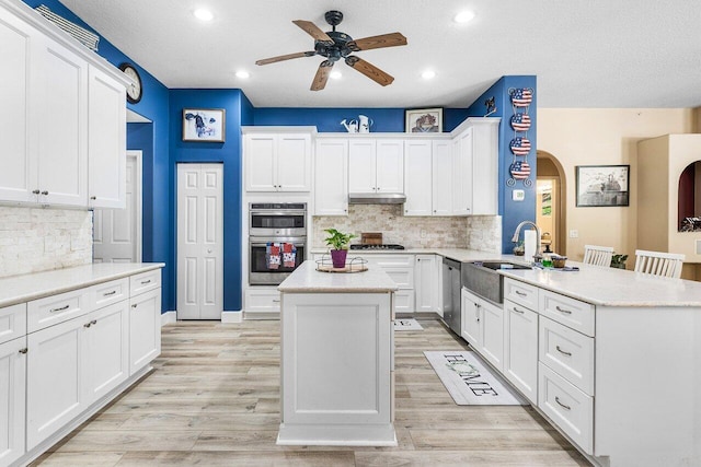 16737 Temple Blvd, Loxahatchee, FL 33470 - kitchen with a sink, a peninsula, a ceiling fan, appliances with stainless steel finishes, and backsplash