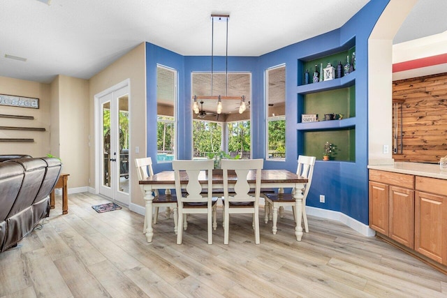 16737 Temple Blvd, Loxahatchee, FL 33470 - dining space featuring light wood finished floors, baseboards, and french doors