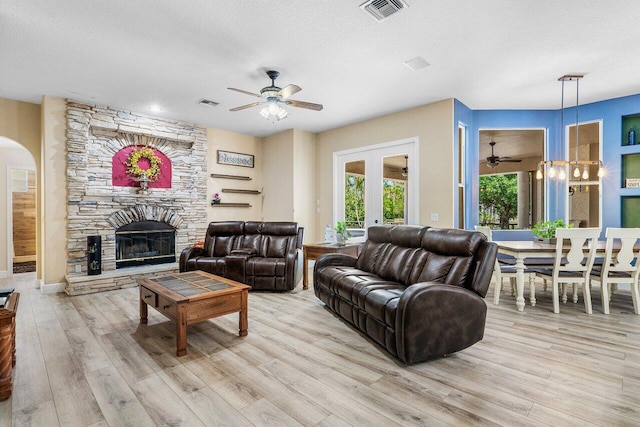 16737 Temple Blvd, Loxahatchee, FL 33470 - living area with ceiling fan, wood finished floors, french doors, a stone fireplace, and a textured ceiling