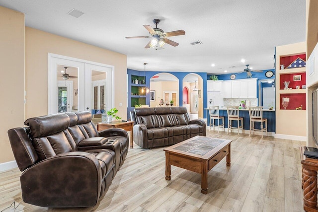 16737 Temple Blvd, Loxahatchee, FL 33470 - living room with a ceiling fan, arched walkways, light wood-type flooring, recessed lighting, and baseboards