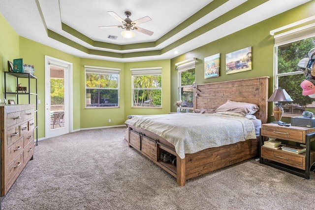 16737 Temple Blvd, Loxahatchee, FL 33470 - bedroom featuring carpet flooring, access to exterior, a raised ceiling, baseboards, and ceiling fan
