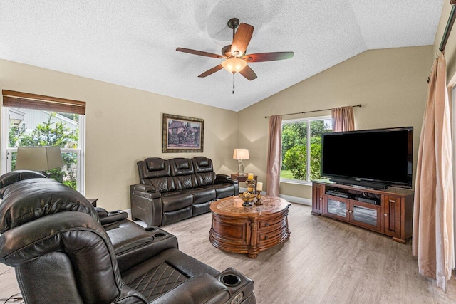 22075 Flower Dr, Boca Raton, FL 33428 - living room with vaulted ceiling, ceiling fan, wood finished floors, healthy amount of natural light, and a textured ceiling