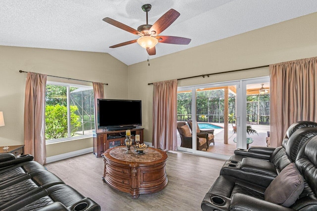 22075 Flower Dr, Boca Raton, FL 33428 - living room with wood finished floors, ceiling fan, vaulted ceiling, baseboards, and a textured ceiling