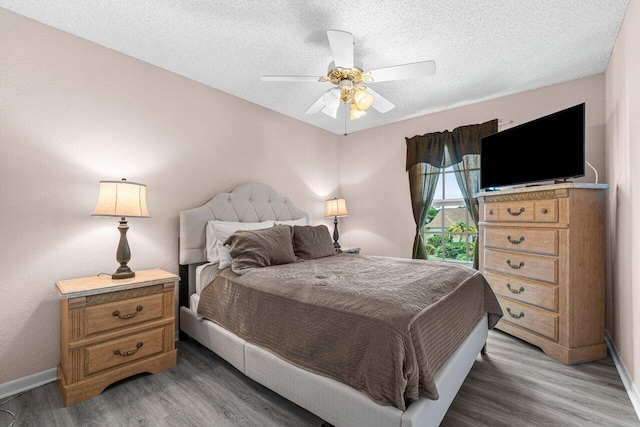 22075 Flower Dr, Boca Raton, FL 33428 - bedroom with light wood-style flooring, baseboards, a textured ceiling, and a ceiling fan