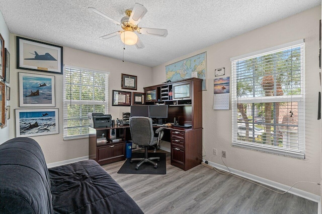 22075 Flower Dr, Boca Raton, FL 33428 - office featuring light wood-style floors, a textured ceiling, a ceiling fan, and baseboards