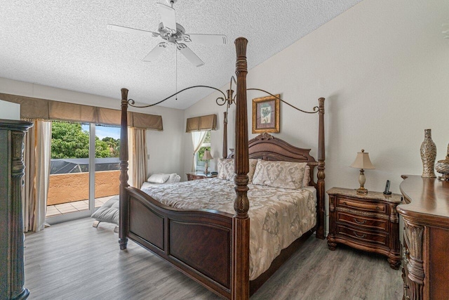 22075 Flower Dr, Boca Raton, FL 33428 - bedroom featuring a textured ceiling, access to exterior, wood finished floors, lofted ceiling, and multiple windows