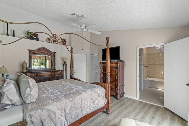 22075 Flower Dr, Boca Raton, FL 33428 - bedroom with vaulted ceiling, a textured ceiling, wood finished floors, and a ceiling fan